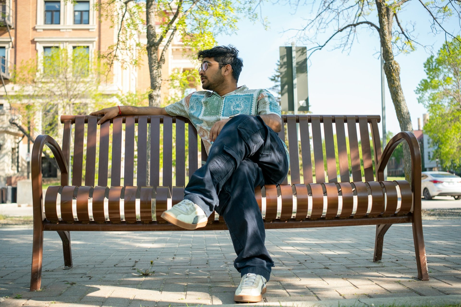 Person sitting on a bench in NYC reflecting during IFS therapy, exploring inner parts with compassion