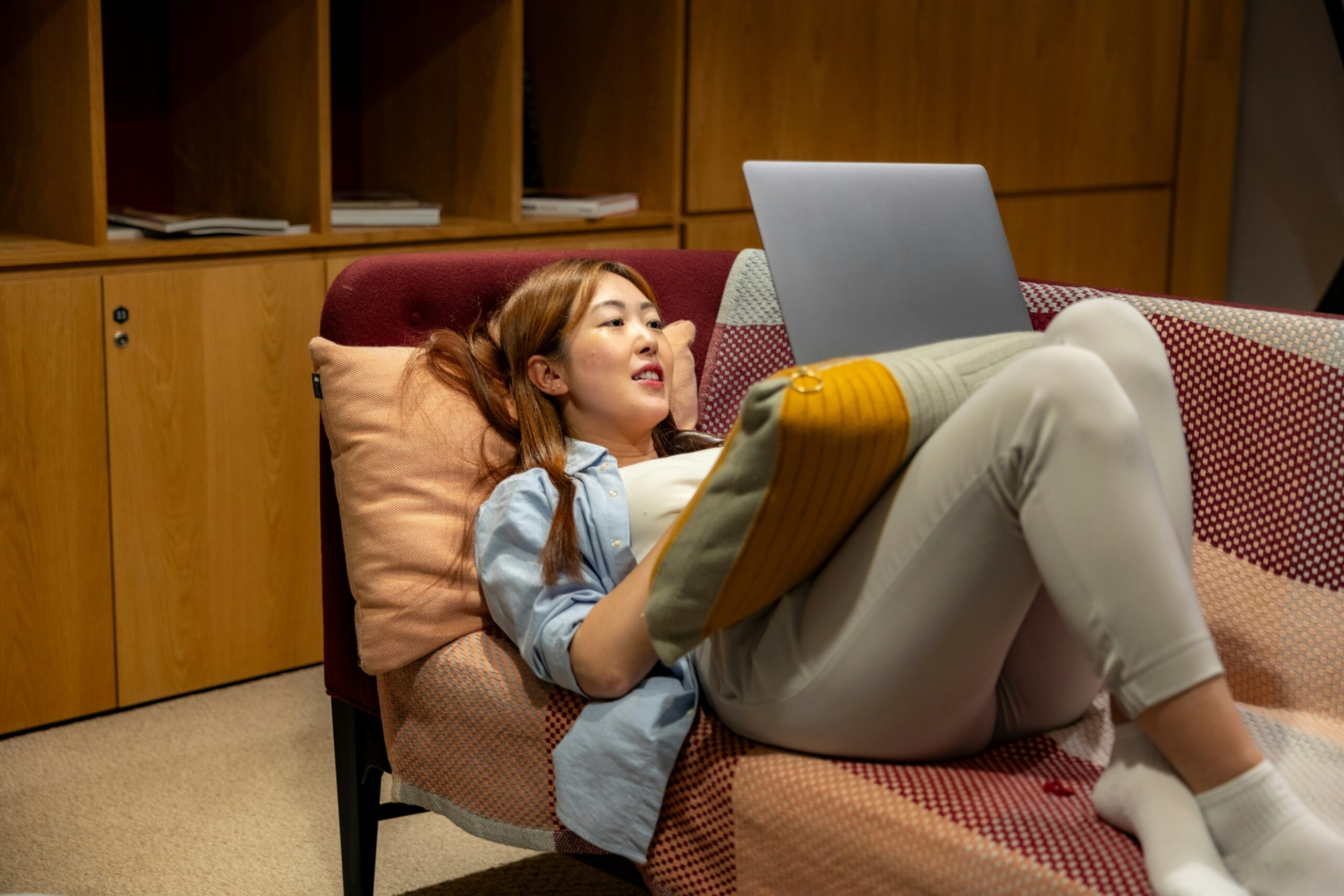 Young woman attending online somatic therapy session from home on her laptop