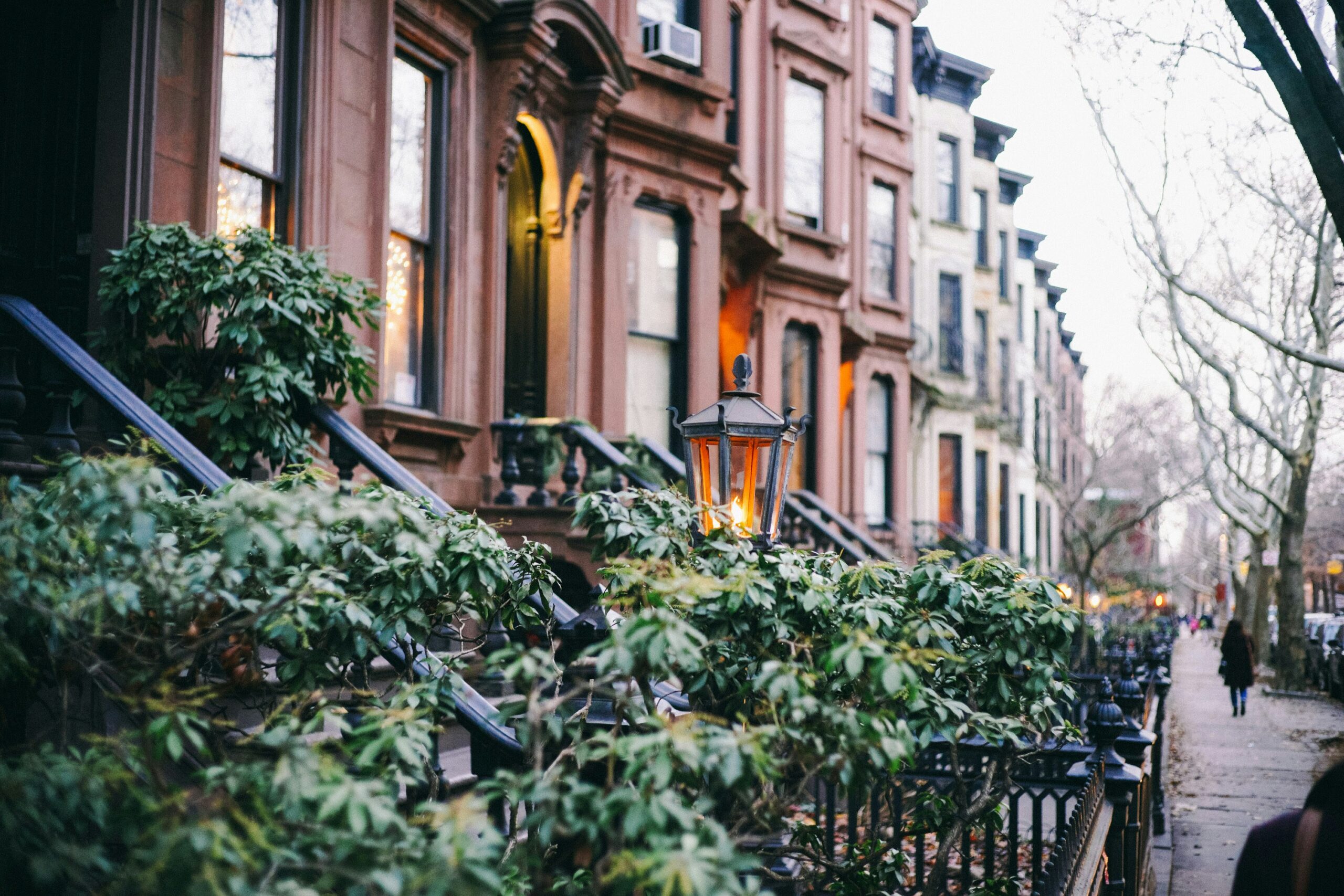 Brooklyn brownstone buildings with warm window lights in Clinton Hill neighborhood where somatic therapy practice is located